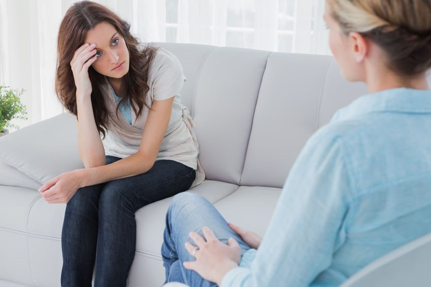 Upset woman sitting on the couch